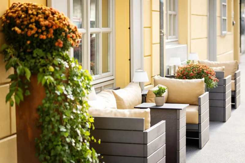 Boutique Hotel Das Tigraの入口前に置かれた植木鉢と屋外席